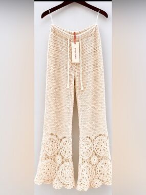 New with tags SOLITAIRE crochet knit flare pants in size Medium.